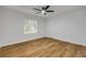 Bright bedroom features wood-look flooring, a ceiling fan, and a window at 2822 Brookline Ave, New Smyrna Beach, FL 32168