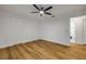 This bedroom features wood-look flooring, a ceiling fan, and an ensuite bathroom at 2822 Brookline Ave, New Smyrna Beach, FL 32168