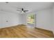 Bright bedroom with hardwood floors and sliding glass door to the backyard at 2822 Brookline Ave, New Smyrna Beach, FL 32168