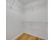 Walk-in closet features white wire shelving and wood-look flooring at 2822 Brookline Ave, New Smyrna Beach, FL 32168