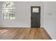 Bright entryway featuring wood-look flooring, a stylish front door, and a window at 2822 Brookline Ave, New Smyrna Beach, FL 32168