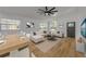 Open living space with stylish furniture, vaulted ceilings, and wood-look flooring at 2822 Brookline Ave, New Smyrna Beach, FL 32168