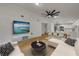 Open-concept living room flows into the kitchen featuring wood-look floors and white walls at 2822 Brookline Ave, New Smyrna Beach, FL 32168