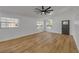 Bright living space featuring wood-look flooring, a modern ceiling fan and large windows at 2822 Brookline Ave, New Smyrna Beach, FL 32168