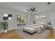 Bright main bedroom with stylish décor, ceiling fan and sliding glass door to patio at 2822 Brookline Ave, New Smyrna Beach, FL 32168