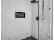 Close up of a modern shower with niche, glass doors and geometric tiling at 2822 Brookline Ave, New Smyrna Beach, FL 32168