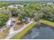 Aerial view of property with mature trees, a large pond and outbuildings at 2917 Crockett Pt, Sanford, FL 32773