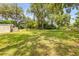 Large backyard with a lush green lawn and mature shade trees, creating a serene outdoor space at 2917 Crockett Pt, Sanford, FL 32773