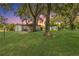 Spacious backyard with mature trees, outbuildings and a picnic table at 2917 Crockett Pt, Sanford, FL 32773