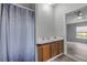 Bathroom featuring a shower, sink, and vanity with wood cabinets, offering functionality and a clean design at 2917 Crockett Pt, Sanford, FL 32773