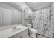 Bright bathroom with a vintage-themed shower curtain, and vanity with a white sink at 2917 Crockett Pt, Sanford, FL 32773