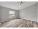 Bright bedroom featuring wood-look floors, neutral paint and a window with natural light at 2917 Crockett Pt, Sanford, FL 32773