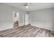 Bright bedroom featuring wood-look flooring with an ensuite bathroom, ceiling fan, and closet at 2917 Crockett Pt, Sanford, FL 32773