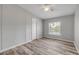 Bedroom with wood-look floors, a window with a view, and a ceiling fan for added comfort at 2917 Crockett Pt, Sanford, FL 32773