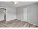 Bright bedroom with modern ceiling fan, wood-look flooring, and closet and bathroom access at 2917 Crockett Pt, Sanford, FL 32773