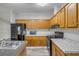 Kitchen featuring oak cabinets and a black appliance set at 2917 Crockett Pt, Sanford, FL 32773