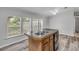 Spacious kitchen featuring a kitchen island, a double sink and windows at 2917 Crockett Pt, Sanford, FL 32773