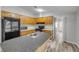 Kitchen featuring wood cabinets, a sink island, and stainless steel appliances at 2917 Crockett Pt, Sanford, FL 32773