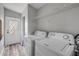 Laundry room with washer and dryer hookups near a door and shelving at 2917 Crockett Pt, Sanford, FL 32773
