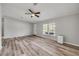 Open living room with modern flooring, ample natural light, and a ceiling fan at 2917 Crockett Pt, Sanford, FL 32773