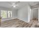 Bright living room with hardwood floors, a ceiling fan, and natural light from the windows at 2917 Crockett Pt, Sanford, FL 32773