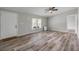 Bright, airy living room with wood-look floors, neutral walls and a ceiling fan at 2917 Crockett Pt, Sanford, FL 32773