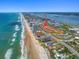 Stunning aerial view of the oceanfront property highlighting its proximity to the beach and ocean at 2961 Oceans Trce, Daytona Beach Shores, FL 32118
