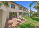 Inviting backyard featuring a stone table set, lush lawn, and tropical palms with access to the property at 2961 Oceans Trce, Daytona Beach Shores, FL 32118