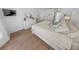 Bright bedroom featuring wood-look flooring, a modern dresser and mirror, and a mounted television at 2961 Oceans Trce, Daytona Beach Shores, FL 32118