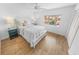 Bright bedroom featuring wood-look flooring, a window, and a ceiling fan at 2961 Oceans Trce, Daytona Beach Shores, FL 32118