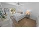Cozy bedroom with a neutral color palette, wood-look floors, and bright natural light at 2961 Oceans Trce, Daytona Beach Shores, FL 32118