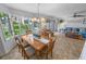 Charming dining room with a large window, chandelier, and a view of the backyard at 2961 Oceans Trce, Daytona Beach Shores, FL 32118