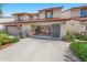 Charming two-story townhouse featuring an open garage, lush landscaping, and a cozy curb appeal at 2961 Oceans Trce, Daytona Beach Shores, FL 32118