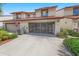 Charming two-story townhouse featuring a screen enclosed garage, lush landscaping, and a cozy curb appeal at 2961 Oceans Trce, Daytona Beach Shores, FL 32118