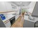 Bright kitchen featuring tile floors, white cabinets, and modern appliances with an eat-in dining area at 2961 Oceans Trce, Daytona Beach Shores, FL 32118
