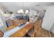 Open-concept dining and living room area with a connecting kitchen and staircase at 2961 Oceans Trce, Daytona Beach Shores, FL 32118