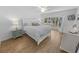 Bright main bedroom featuring wood floors, large windows, and comfortable bedding, with access to backyard at 2961 Oceans Trce, Daytona Beach Shores, FL 32118