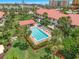 Aerial view of a community pool surrounded by palm trees and well-manicured lawns, creating a resort-like atmosphere at 2961 Oceans Trce, Daytona Beach Shores, FL 32118