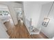 Clean staircase with light-colored wood steps, white railings, and modern lighting fixtures overhead at 2961 Oceans Trce, Daytona Beach Shores, FL 32118