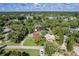 Aerial view of neighborhood with mature landscaping. Subject property has manicured lawn and covered parking for boat at 3048 Mango Tree Dr, Edgewater, FL 32141