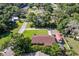 Aerial view of a home with well-manicured lawn and mature trees. Also features a covered carport at 3048 Mango Tree Dr, Edgewater, FL 32141