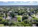 Wide aerial view showcasing neighborhood, mature landscaping and the subject property, with covered boat storage at 3048 Mango Tree Dr, Edgewater, FL 32141