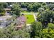 Overhead shot of home with expansive lawn, driveway, mature landscaping and a covered carport at 3048 Mango Tree Dr, Edgewater, FL 32141