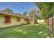 Expansive backyard with wood fence and a mix of sunny and shady areas at 3048 Mango Tree Dr, Edgewater, FL 32141