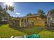 The backyard features a covered porch, fenced in yard and a built in grill at 3048 Mango Tree Dr, Edgewater, FL 32141