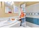 Cozy bathroom featuring a tub with blue and white tile, a bright poppy shower curtain, and clean white fixtures at 3048 Mango Tree Dr, Edgewater, FL 32141