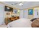 This room features a TV, shelving unit and ensuite bathroom, offering a blend of comfort and convenience at 3048 Mango Tree Dr, Edgewater, FL 32141