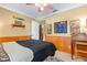 Relaxing bedroom features classic wood paneling, decorative shelving, and a glimpse into the adjoining room at 3048 Mango Tree Dr, Edgewater, FL 32141