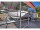 Boat on trailer under the covered carport with a 'For Sale' sign, ideal for boating enthusiasts at 3048 Mango Tree Dr, Edgewater, FL 32141