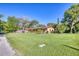 A beautiful property with a lush green lawn, mature trees, and an inviting front porch at 3048 Mango Tree Dr, Edgewater, FL 32141